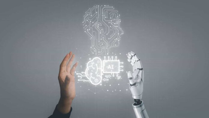 Mãos de humano e de robô espalmadas; entre elas, a representação de uma cabeça humana formada por circuitos e um chip de computador escrito 
